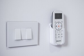 A wall-mounted light switch and a digital thermostat control panel. - Casa Due Agosto Sleek and Central (Bologna)