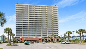 A multi-story hotel with a uniform exterior, featuring balconies on each floor. - Sanibel 306- Beach Access Gulf Views Sun Deck (Gulf Shores)