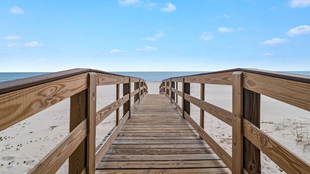 A wooden boardwalk leading to a beach with clear skies. - Lei Lani 218 Best of Beach Bay (Orange Beach)