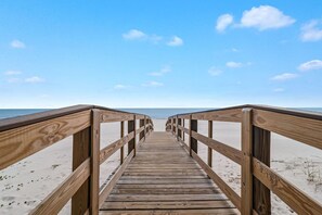 A wooden boardwalk leading to a beach with clear skies. - Lei Lani 218 Best of Beach Bay (Orange Beach)