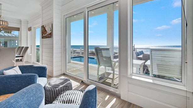 A spacious room with a large sliding glass door leading to a balcony with a pool view. - Lil Tip Sea 8 BR Private Pool Elevator Beach (Gulf Shores)