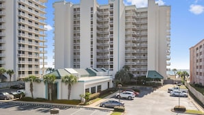 A multi-story hotel with a central building and smaller structures.