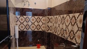 A modern bathroom with a shower, toilet, and sink.