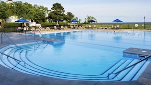 A swimming pool with multiple lanes, lounge chairs, and umbrellas. - House with Hot tub, close to Marina, in a Golf Course Community (Hertford)