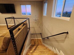 A staircase with wooden steps and a metal railing, leading to a balcony with a view of the sky and landscape. - 3-D Tour my 14Bd/14B with Pool and Spa. Close to Airport, Strip & Conventions (Las Vegas)