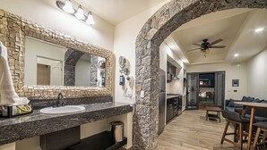 A modern bathroom with a granite countertop, two sinks, and a large mirror. - Hotel Suites Cristal Casa Vacacional (San Miguel de Allende)