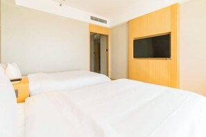 A hotel room with two beds, a TV mounted on the wall, and a door leading to another room. - Elong Hotel (Beijing Shijingshan Gucheng Subway Station) (Beijing)