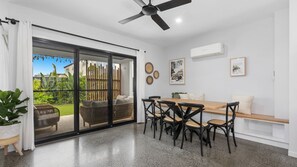 Enjoy meals in the dining area with a sliding door leading to the outdoor space.