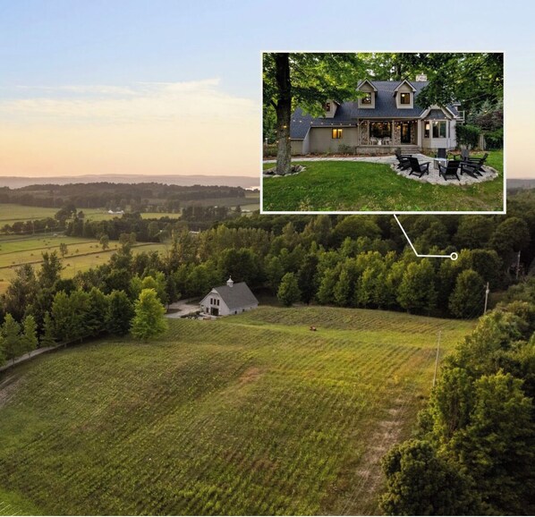 Situated in a serene rural landscape, this traditional house offers a peaceful retreat surrounded by a well-maintained lawn and garden.