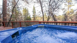 A hot tub surrounded by a wooden deck and trees. - Overlook Retreat- Awesome Views, Pets Welcome! (Big Bear City)