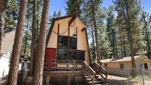 A cabin with a wooden deck, stairs, and a window. - Sherwood Cabin-2bed+Loft (Big Bear City)