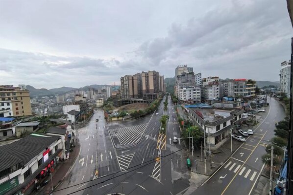 A cityscape with buildings, roads, and a crosswalk. - Pusafeyou Hotel (Pu'an)