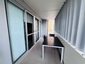 Stroll through this serene corridor, lined with large windows and a minimalist bench.