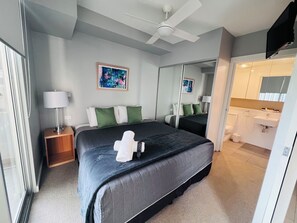 Relax in a spacious room with a large bed, bedside table, and modern amenities.