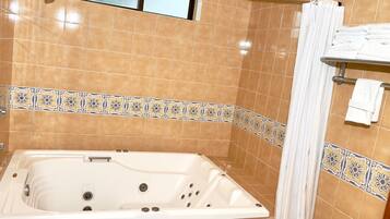 Comfort Room, 1 King Bed | Bathroom | Hydromassage showerhead, free toiletries, hair dryer, heated floors
