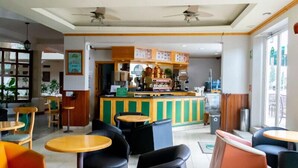 A cafe with a counter, chairs, and tables.