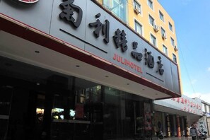 A hotel with a prominent sign, multiple windows, and a clear view of the street. - Juli Boutique Hotel (Kunming Jinma Zhengchang Fruit Market Juhua Subway Station) (Kunming)