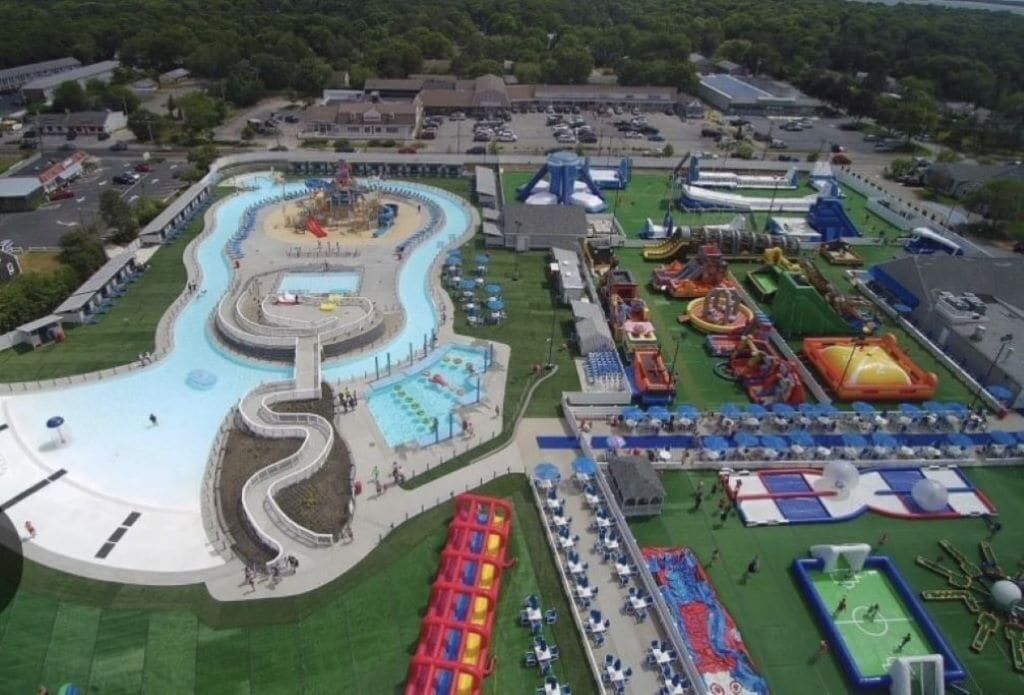 A water park with a winding water slide, multiple pools, and various play areas.