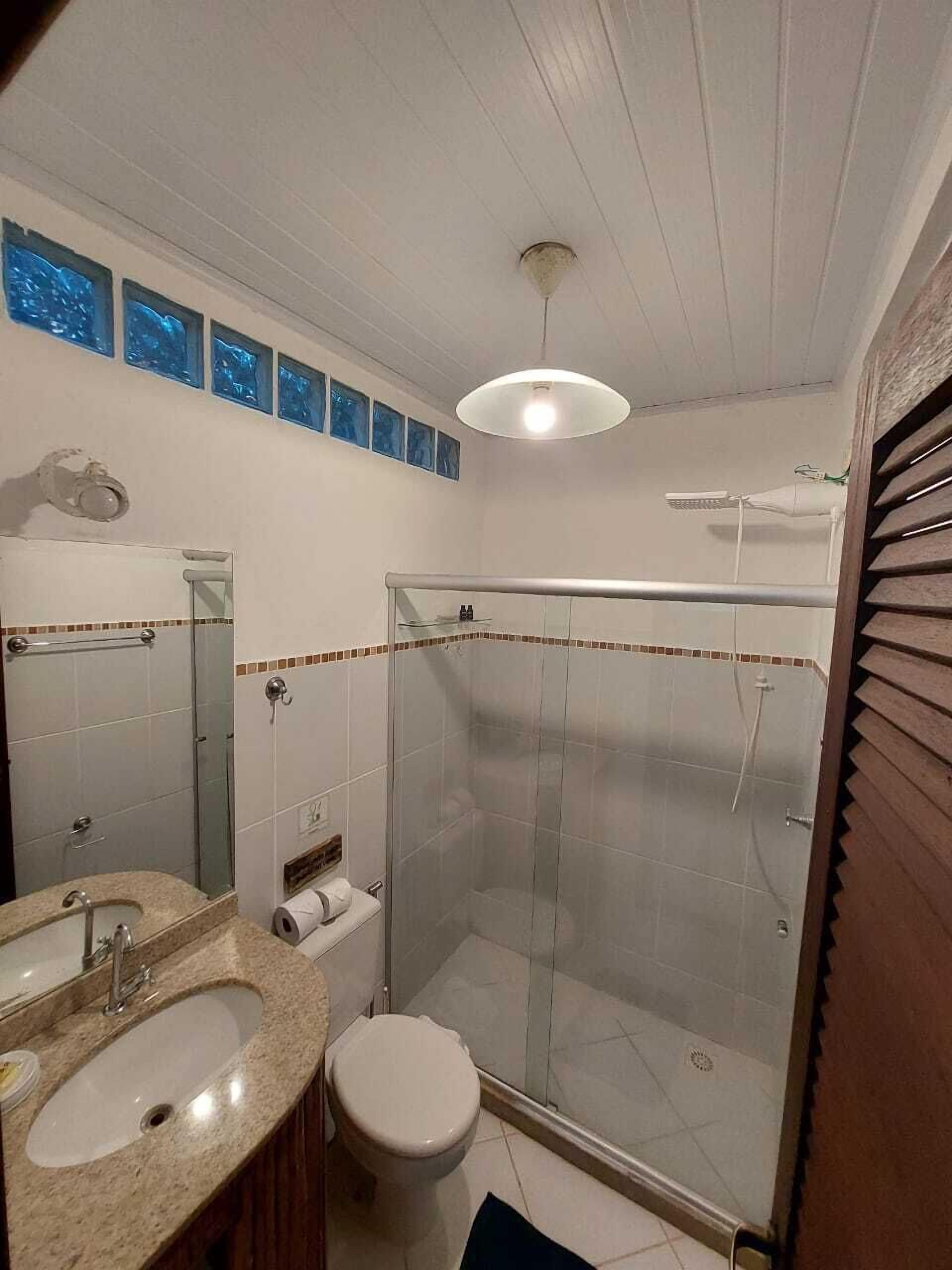 Estudio Orquidea | Bathroom | Shower, towels, soap, toilet paper