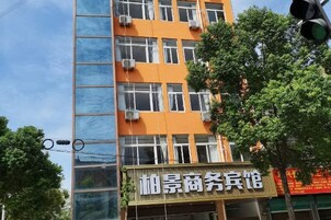 A multi-story building with a commercial establishment on the ground floor.