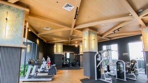 A gym with treadmills, elliptical machines, and weight equipment. - Cozy And Well Furnished Studio Collins Boulevard Apartment (Tangerang)