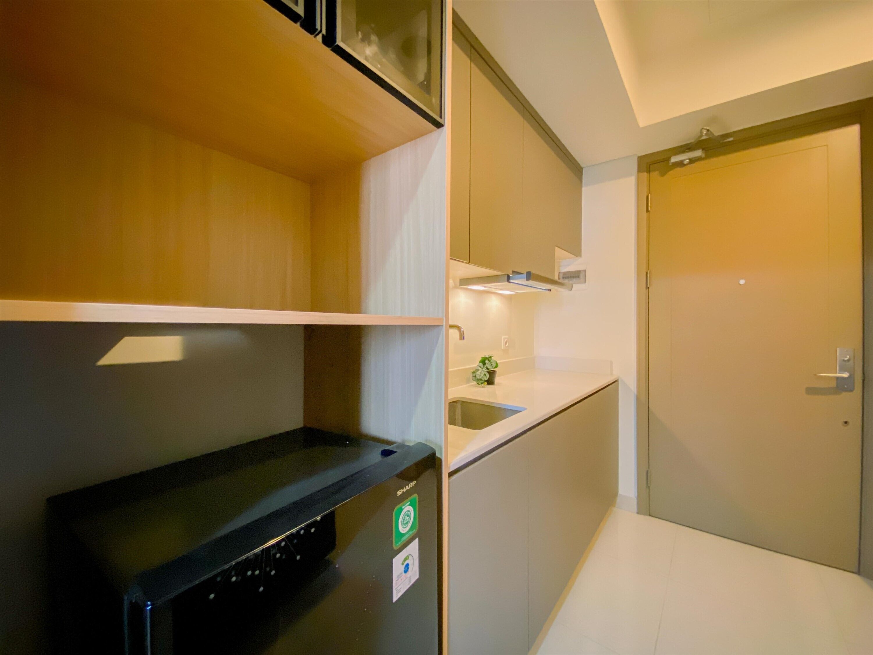 A compact kitchen with a built-in oven, a sink, and a small countertop.