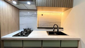 Apartment | Private kitchen | Fridge, stovetop, rice cooker, dining tables - Warm And Homey 2Br At Vida View Makassar Apartment (Makassar)