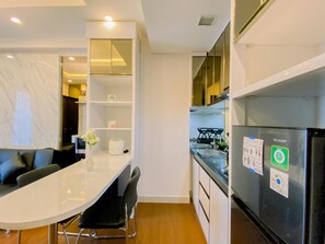 Apartment | Private kitchen | Full-size fridge, stovetop, rice cooker, dining tables