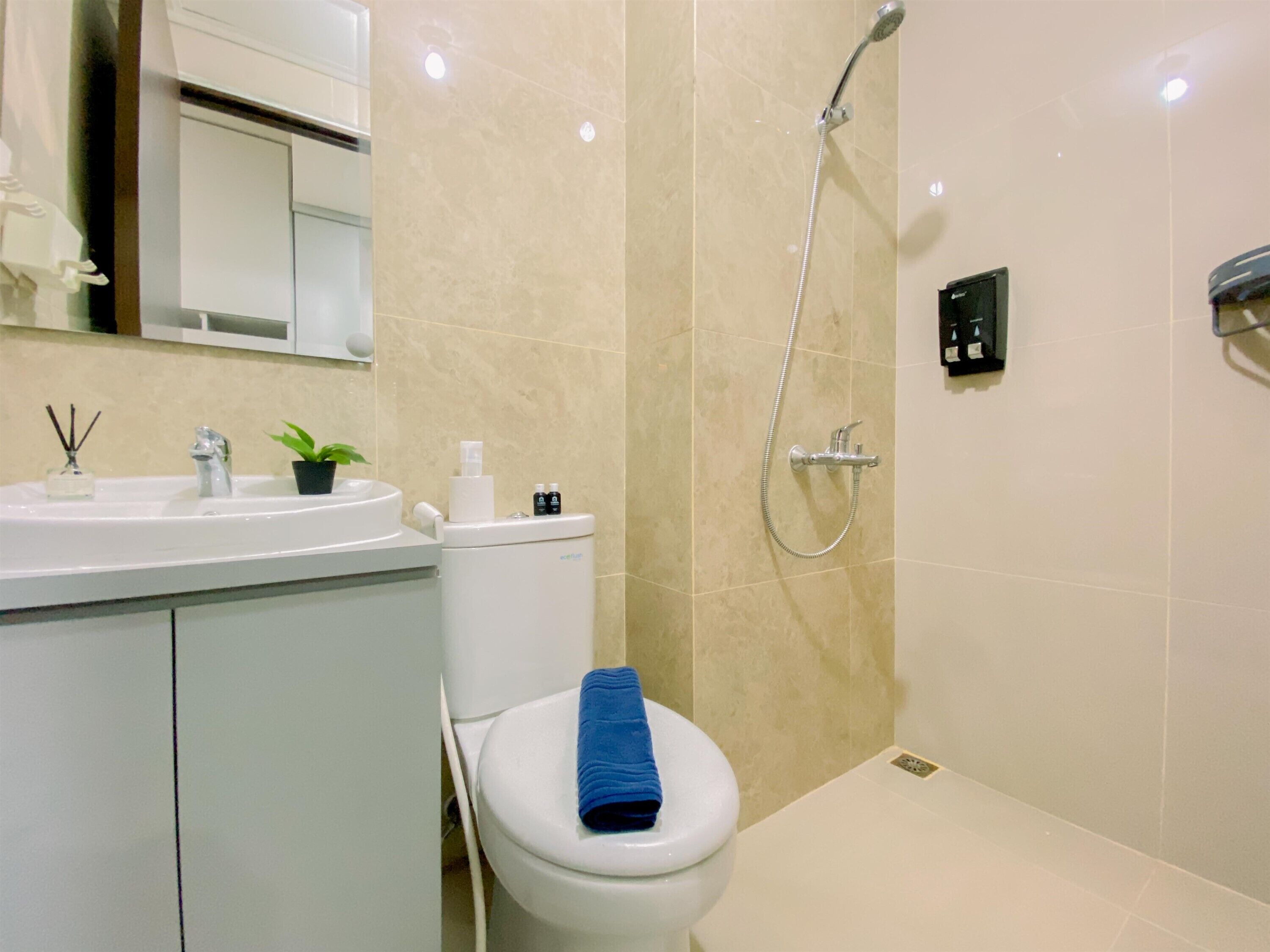 A bathroom with a toilet, sink, and shower.