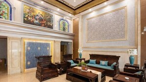 A spacious lobby with a high ceiling, ornate wall decorations, and multiple seating areas. - Bolin Hotel (Zhongshan)