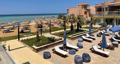 Enjoy Beachfront apartment at elite resort , pool, Wi-Fi, unique location.