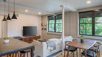 Deluxe Suite, 1 King Bed | Living area | LCD TV, Netflix, streaming services, music library