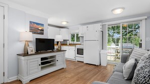 A modern kitchen with white cabinets, a wooden countertop, and a built-in oven. - Relax at Hilltop Hideaway, Near the Shore (Dennis Port)