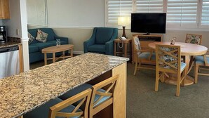 A compact living space with a kitchen, dining area, and seating.