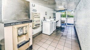 A laundromat with a sign indicating the motel is not responsible for items left unattended. - Motel 6 – Colorado Springs, CO – South/Metro Area (Colorado Springs)