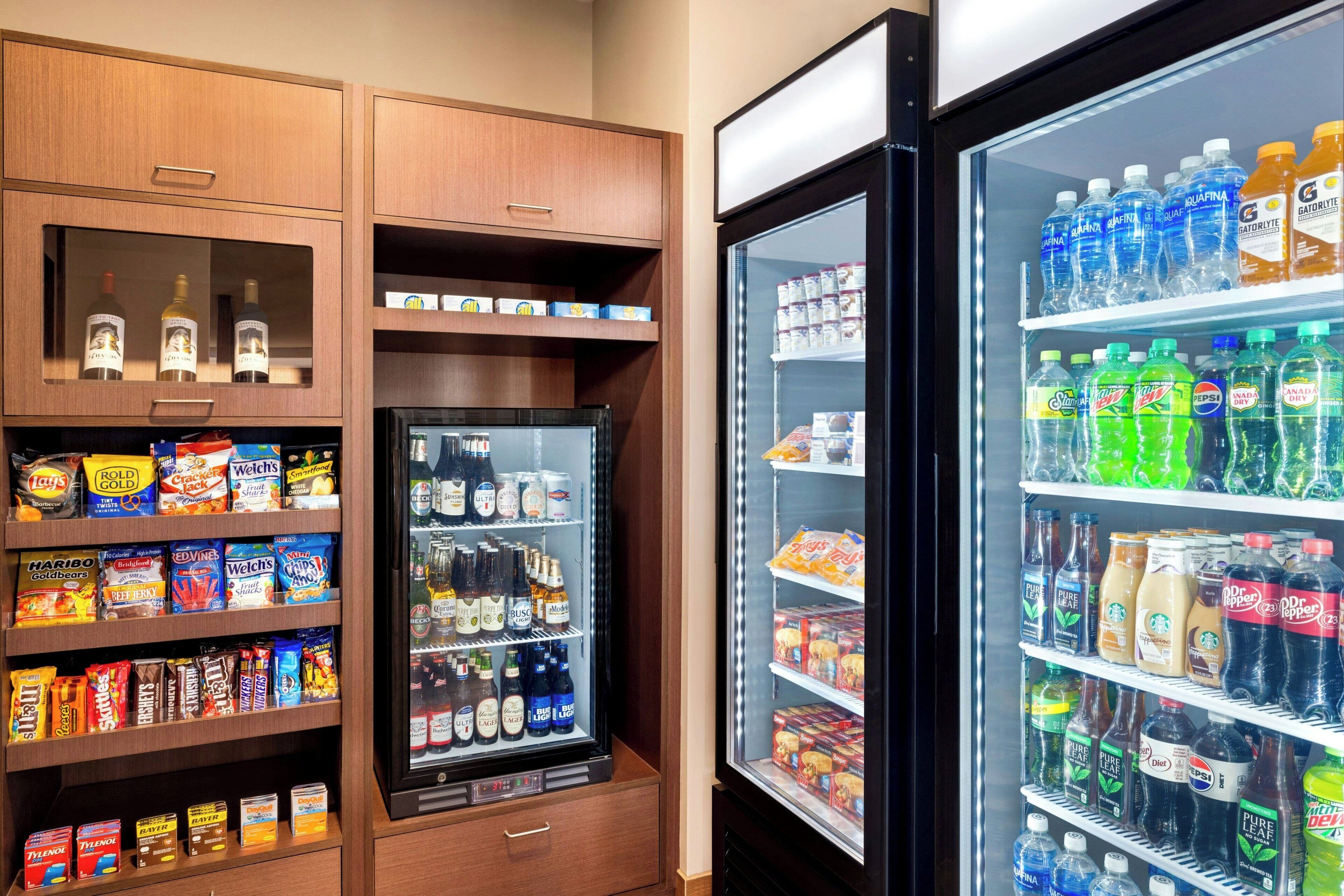 A vending machine stocked with snacks, beverages, and ice cream.