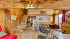 A wooden interior with a staircase, dining area, and kitchen. - Apartment 'Le Pelvoux' with Balcony (Les Deux-Alpes)