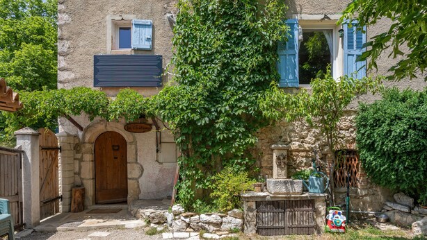 A rustic stone building with a wooden door, a stone bench, and a small garden area. - Cottage for Four in Nature – Préalpes d'Azur Regional Natural Park (Valderoure)