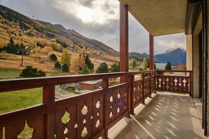 A balcony with a view of a mountainous landscape.