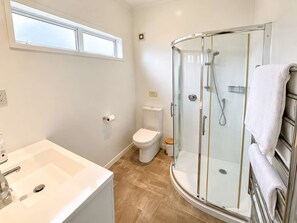 Shower, hair dryer, towels, shampoo