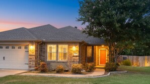 A two-story house with a garage, a front porch, and a well-maintained lawn. - 4 Bedroom, 2 Bath in Midlothian! Centrally Located, Pet Friendly, Close to Local Wedding Venues. (Midlothian)