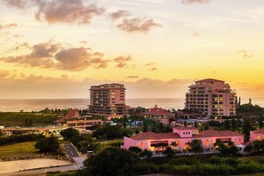 A coastal hotel complex with multiple buildings, including a prominent tower and several smaller structures. - Hotel Shigira Mirage Beach Front (Miyakojima)