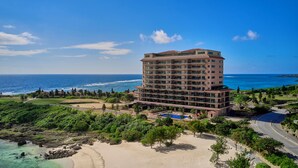 A multi-story hotel with a pool, beachfront location, and ocean views. - Hotel Shigira Mirage Beach Front (Miyakojima)