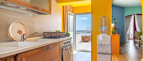A kitchen with wooden cabinets, a sink, and a built-in oven.