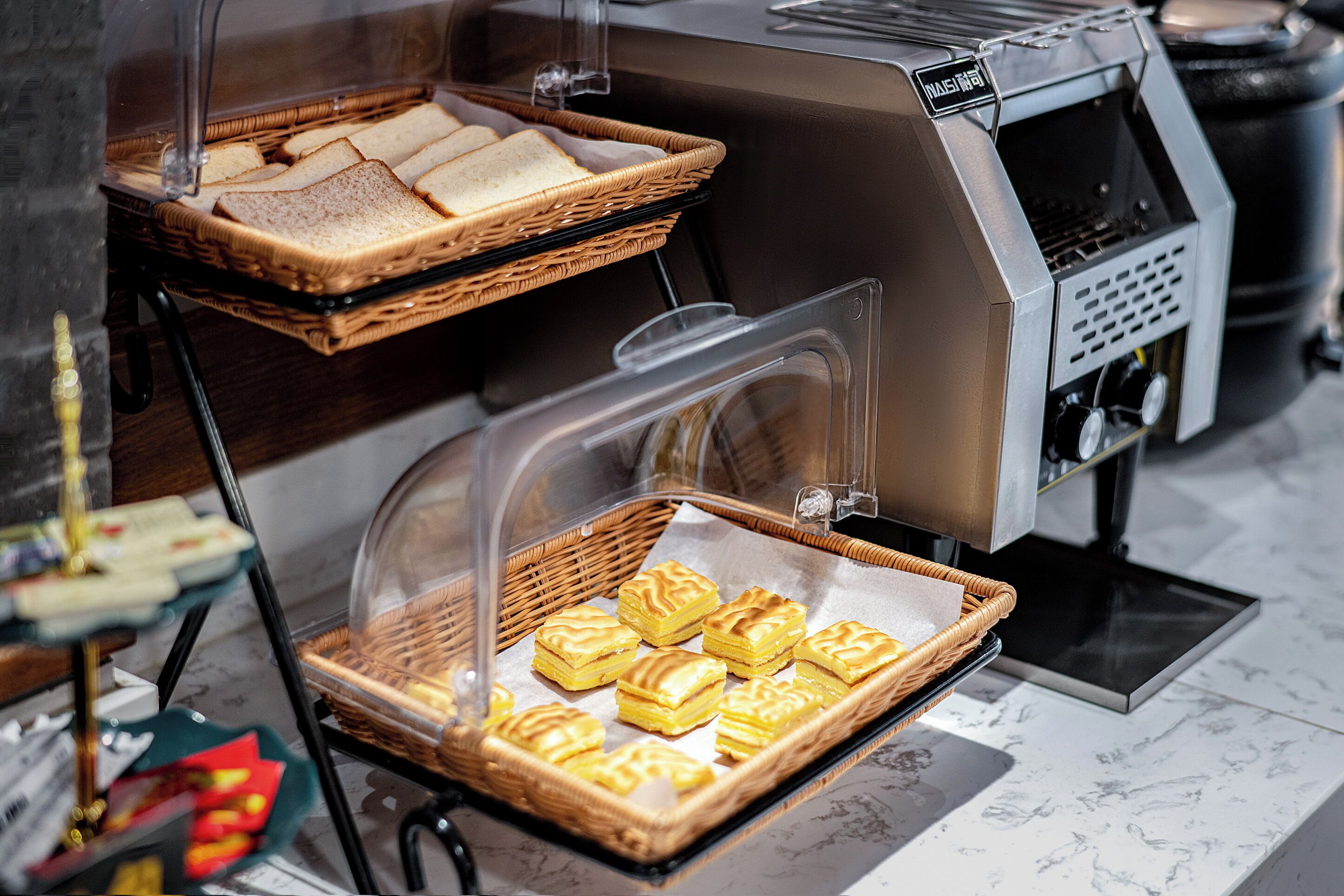 A buffet area with baskets of sandwiches and pastries.