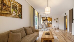 A modern living room with a sofa, a coffee table, and a painting on the wall. - Apartment 'Neue 4 Zi Küche Bad Parknähe' with Balcony and Wi-Fi (Neunkirchen)