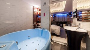 Ein modernes Badezimmer mit einer großen Badewanne, einem separaten Waschbecken und einer Duschkabine.