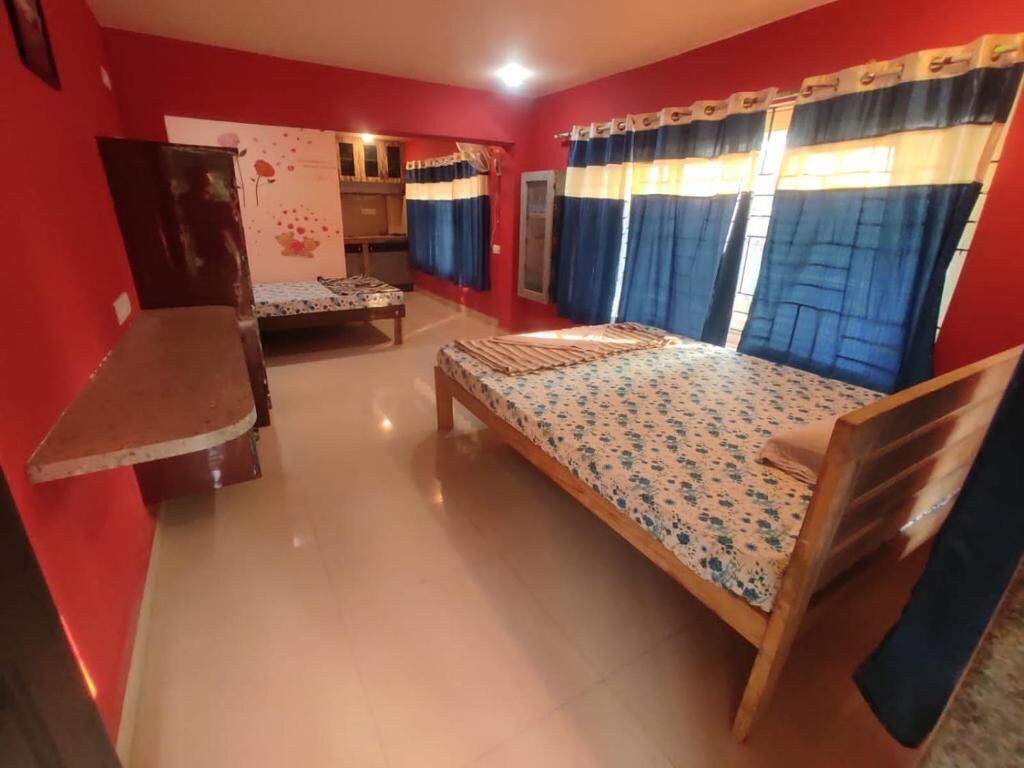 A room with a bed, a desk, and a chair.