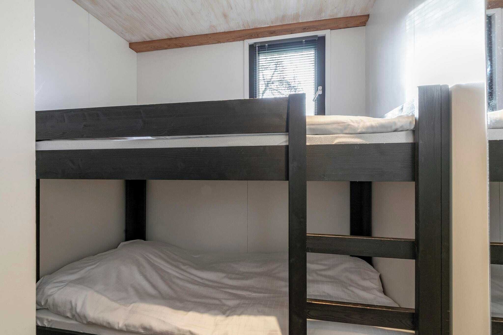 A bunk bed room with a window and a door.