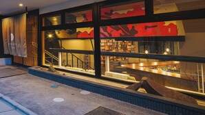 A modern building with large windows, a staircase, and a well-lit interior. - Giappo Franca Kyoto (Kyoto)